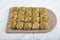 Turkish Midye Baklava  Mussel Shape Baklava  with green pistachio Powder and Butter Cream. Famous Turkish Gaziantep baklava