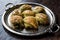 Turkish Midye Baklava Mussel Shape Baklawa with green pistachio Powder and Butter Cream in Silver Tray.