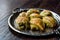 Turkish Midye Baklava Mussel Shape Baklawa with green pistachio Powder and Butter Cream in Silver Tray.