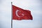 Turkish national flag over blue sky