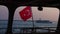 Turkish national flag on the stern of ferry against background of sunset at sea