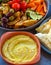 Turkish platter bowls of pita bread, hummus and grilled veggies