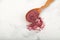 Turkish powdered fruit tea. Instant drink in wooden spoon, close-up. Selective focus, copy space