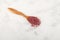 Turkish powdered fruit tea. Instant drink in wooden spoon on light textured surface, top view. Selective focus, copy space
