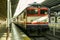 Turkish railways passenger express train arriving in the Sirkeci Gar train station during a sunny sunset.