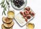 Turkish sun dried olives, figs, homemade cheese, white wine - delicious appetizers on a light background, top view