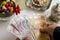 Turkish thousand lira in hand of older person on white with cologne,colorful candies and Turkish coffee set