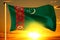 Turkmenistan flag weaving on the beautiful orange sunset with clouds background