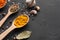 Turmeric, bay leaves and garlic on dark table