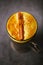 Turmeric latte or golden milk with cinnamon stick