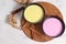 Turmeric latte and pink-golden milk for immunity, ginger and cinnamon on a gray table, helps fight viruses, has antioxidant
