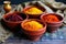 turmeric, paprika, and saffron threads in bowls