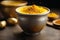 Turmeric powder in a bowl on a wooden background