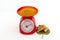 Turmeric powder and fresh turmeric root in red weight scale on