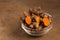 turmeric powder in jar dish on brown background