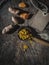 Turmeric powder and rhizome on wooden ladle. Overhead of vintage wooden table