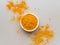 Turmeric powder. Traditional indian golden healthy spice in white ceramic bowl on gray background. Top view