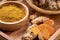 Turmeric Powder and Turmeric root in wooden plate, Curry Powder on a wooden table background