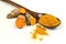 Turmeric powder in a wooden spoon and isolated turmeric roots on a white background. Turmeric helps reduce fat.