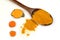 Turmeric powder in a wooden spoon and isolated turmeric roots on a white background. Turmeric helps reduce fat.
