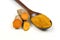 Turmeric powder in a wooden spoon and isolated turmeric roots on a white background. Turmeric helps reduce fat.