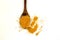 Turmeric powder in a wooden spoon and isolated turmeric roots on a white background. Turmeric helps reduce fat.