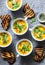 Turmeric pumpkin vegetarian soup on grey background, top view. Flat lay butternut squash soup served in mugs