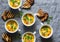 Turmeric pumpkin vegetarian soup on grey background, top view. Flat lay butternut squash soup served in mugs