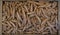 Turmeric roots in a wooden box, photographed from above. Turmeric is a cooking spice and has a variety of medicinal properties