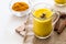 Turmeric tea drinks with milk and honey for beauty and health. Spicy healthy Haldi