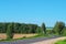 Turn of asphalt road crossing a rural field