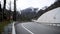 Turn on country road in forest mountain area. Traffic passing cars mountain winding road through forest on background of