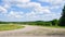 Turn of empty dirt road in countryside at summer day