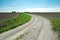 Turn on a gravel road through farmland and blue sky