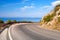 Turn of mountain highway with blue sky and sea