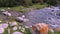 Turn of mountain river flow with stones on summer day in Kyrgyzstan