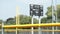 turned off baseball electronic digital scoreboard on posts in outfield with time 131 v