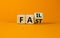 Turned wooden cubes with text `fail fast` on beautiful orange background. Business and fail fast concept. Copy space