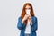 Turning on photo filter. Cheerful and cute female redhead lifestyle blogger, taking picture on smartphone, holding