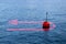 At the turning point - concept image with a red bouy on a calm lake and red arrow that comes back