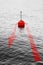 At the turning point - concept image with a red bouy on a calm lake and red arrow that comes back