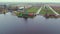 Turning windmill of Zaans Schans museum by the water channel, panoramic drone view, Netherlands