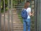 Turnstile, restricted entry. A lady travels through a turnstile to a private Park.