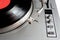 Turntable in silver case with vinyl record with red label isolated on white background. top