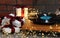 Turntable with vinyl record, fairy lights and Christmas gift boxes on grey table, closeup