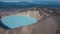 Turquoise acidic lifeless lake in the crater of a volcano.