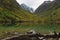 Turquoise Baduk lake in mountains in Dombay national park, Caucasus, Russia. Beautiful autumn landscape with reflections in clear