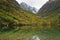 Turquoise Baduk lake in mountains in Dombay national park, Caucasus, Russia. Beautiful autumn landscape with reflections in clear