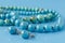 Turquoise beads on blue background