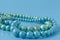 Turquoise beads on blue background